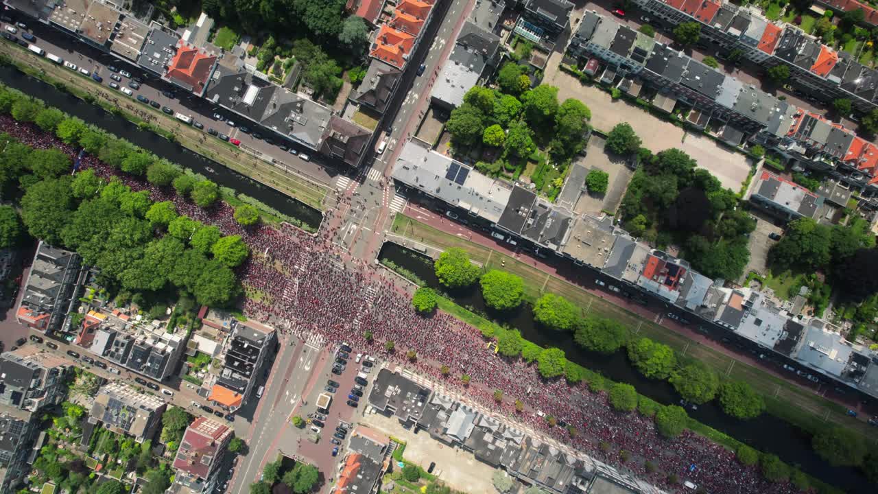 Palestine protest Drone aerial shows massive group of people on highway in the Hague, Red line top down view