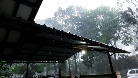 Heavy-rain-and-hail-falling-on-shed-roof-in-Magelang,-Indonesia