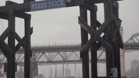 Ferry dock sign on wooden construction with seagull on the top