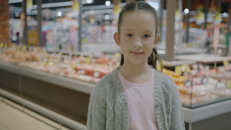girl smiling in a grocery store