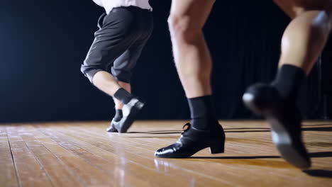 dancers performing on a wooden stage