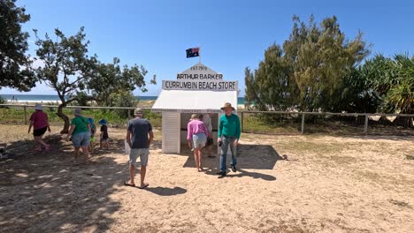 group walking towards beach store sign