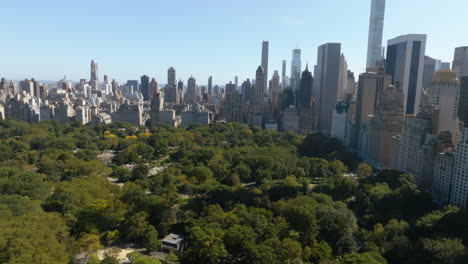 aerial view rising over the central park, toward lenox hill, in sunny ny, usa