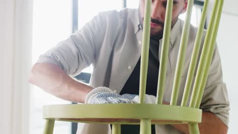 Man-Applying-Solvent-to-Rag-and-Cleaning-Old-Chair