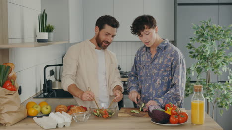 couple cooking a salad together in the kitchen