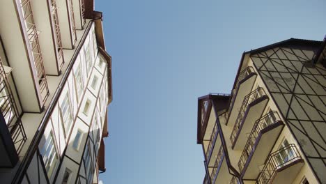 two apartment buildings under a clear sky