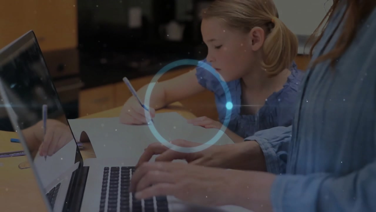 Mother typing on laptop guiding daughter writing in education notebook during spinner appearing