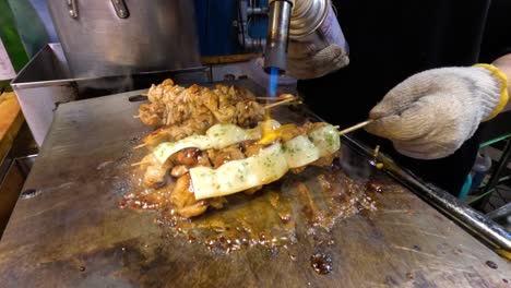 cooking and basting skewers on a hot grill