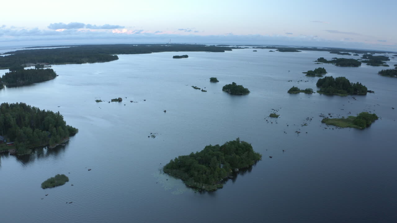 Drone rotating in front of islands in the archipelago, summer dusk in Finland