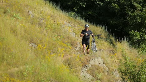 man cycling on the path. male cyclist riding a bike uphill along a path