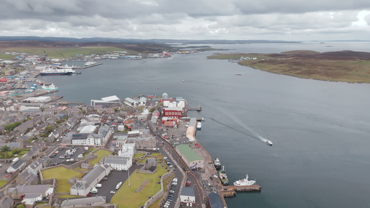 An aerial shot of the harbour town of Lerwick, Shetland in Scotland, sweeping over the port area.