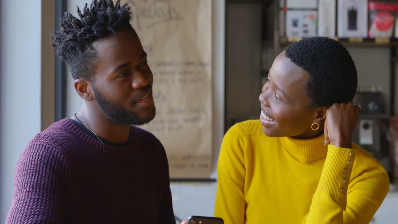 Couple interacting with each other in cafe 4k