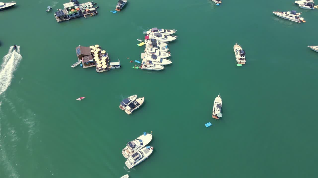 Above View Of Charter Yachts And Floating Bars At The Beach Of Porto Belo In Santa Catarina, Brazil. Aerial Drone Shot