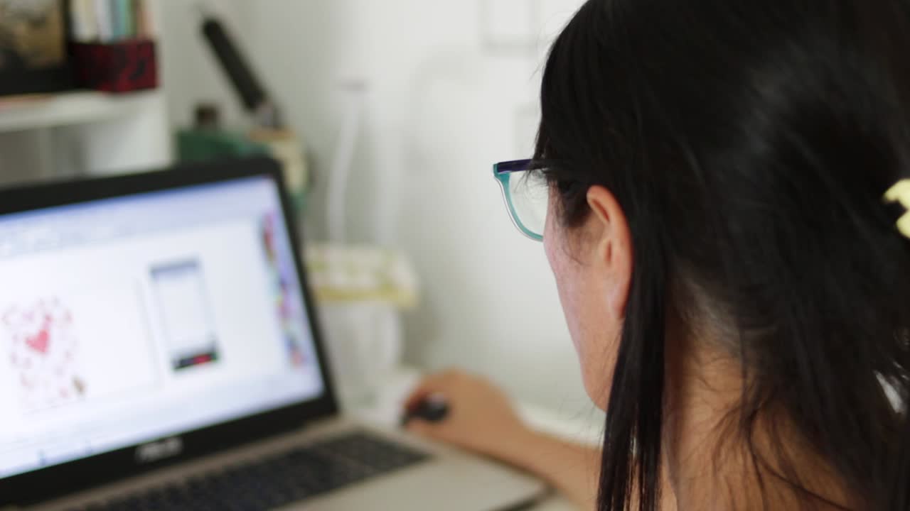 Black-haired woman designing on computer