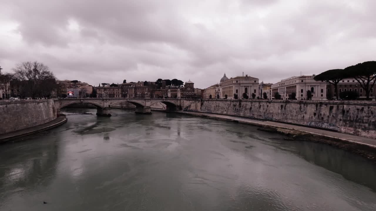 Exploring the historic riverside views of Rome under a cloudy sky