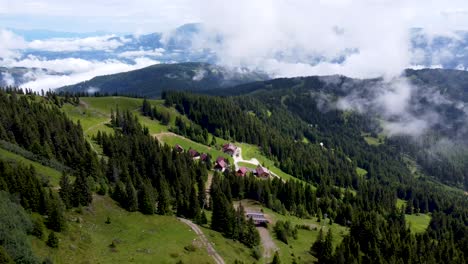 Slow-drone-ride-over-sunny-mountain-village-in-green-Austrian-Alps