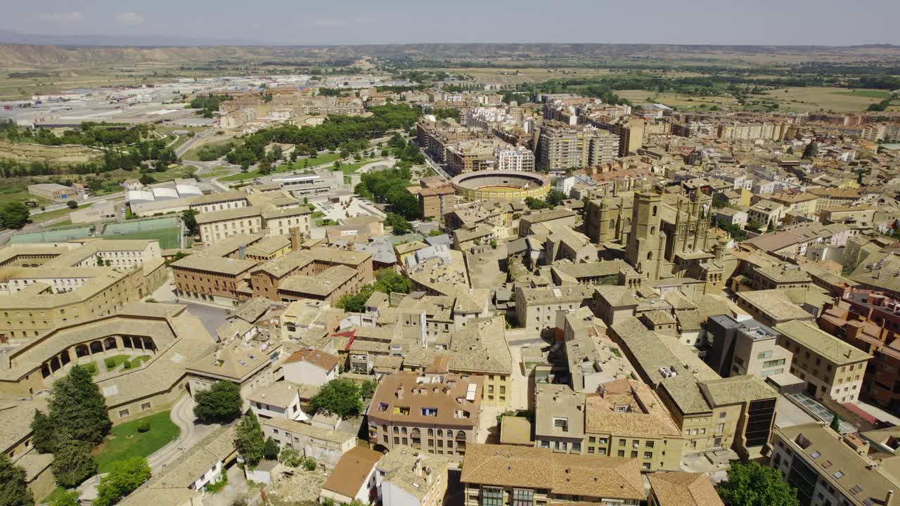 Aerial view of a historic Spanish town featuring a cathedral and bullring