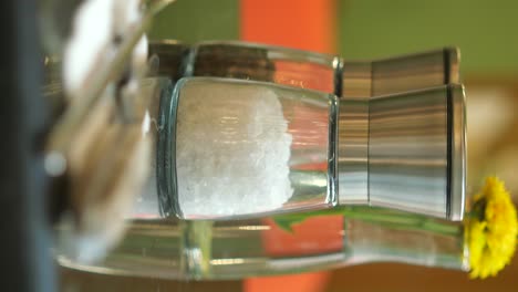 salt and pepper shakers on a mirrored table