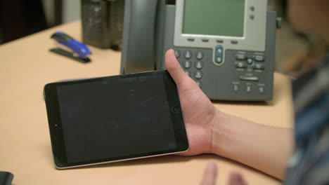 man checking out the screen of his tablet 4k