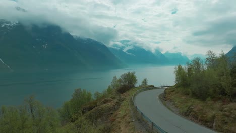 winding road next to fjord in norway