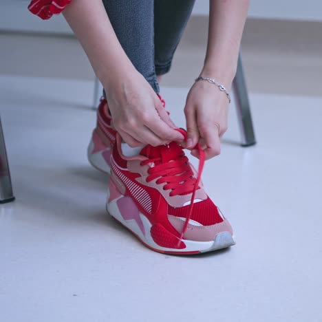 woman tying shoelace indoor