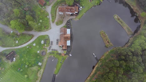 Aerial-footage-of-forest-with-a-climatic-house-in-the-middle