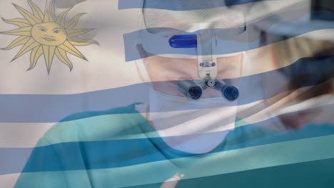 animation of flag of uruguay flag waving over surgeons in operating theatre