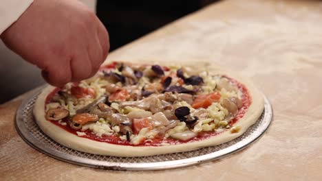 chef preparing a seafood pizza