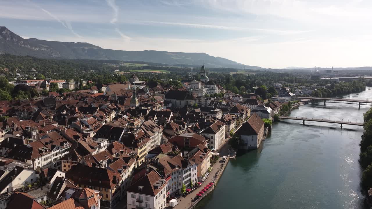 Drone view of Olten’s old town, river Aare, and surrounding mountains in summer sunlight