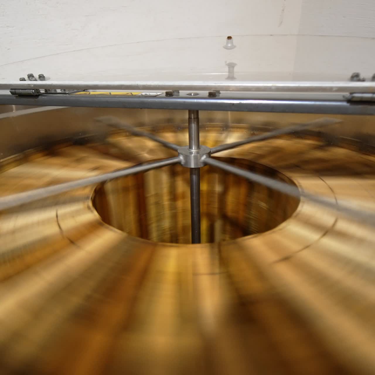 Extracting fresh organic honey in the electric centrifuge appliance. Special machine with centrifuge mechanism rotates the frames with honey