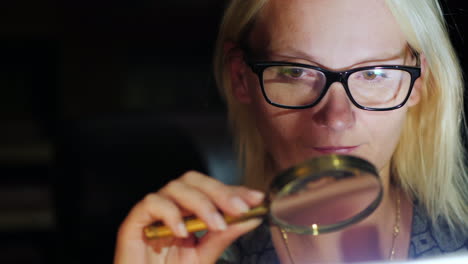 woman using magnifying glass