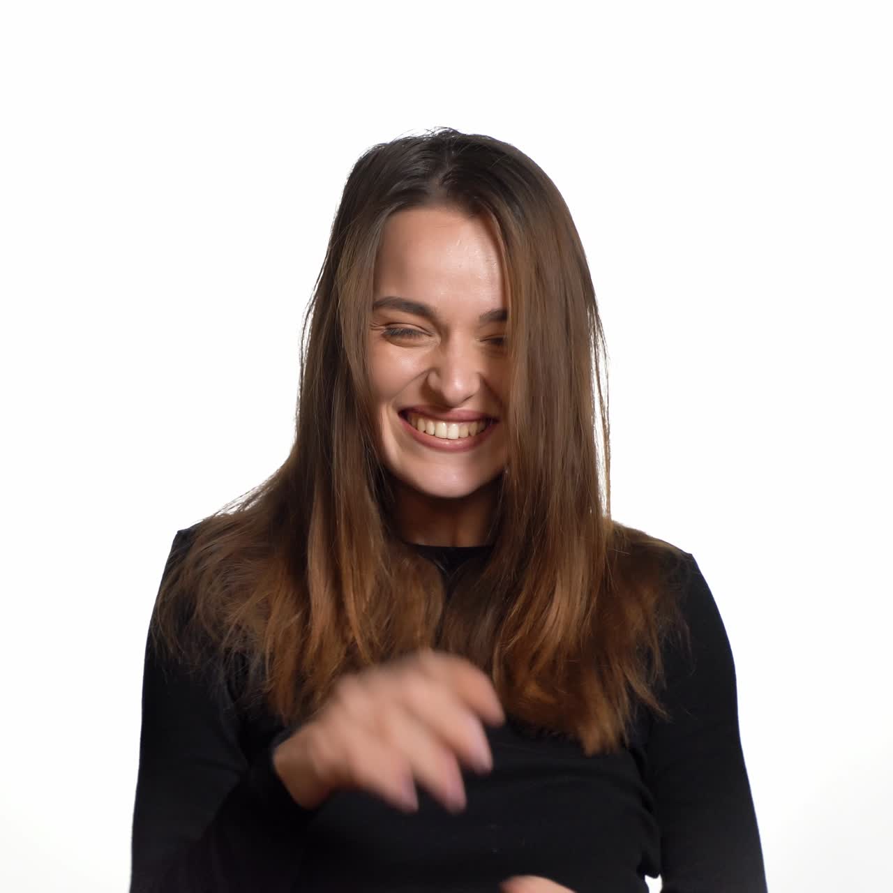 Positive human emotions. Pretty young woman with shopping bags after successful shopping, smiling and looking at the camera on a white background