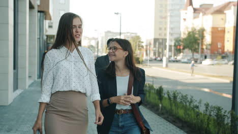 businesswomen walking and talking