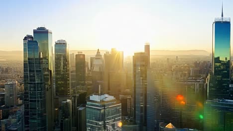 sunrise illuminating a modern city skyline, creating a beautiful lens flare effect against the urban landscape