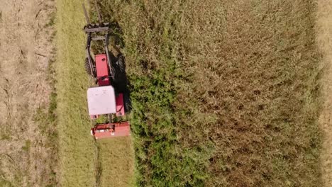 Farmer-Driving-A-Tractor-Trailer-On-A-Farm-Field-Terrain