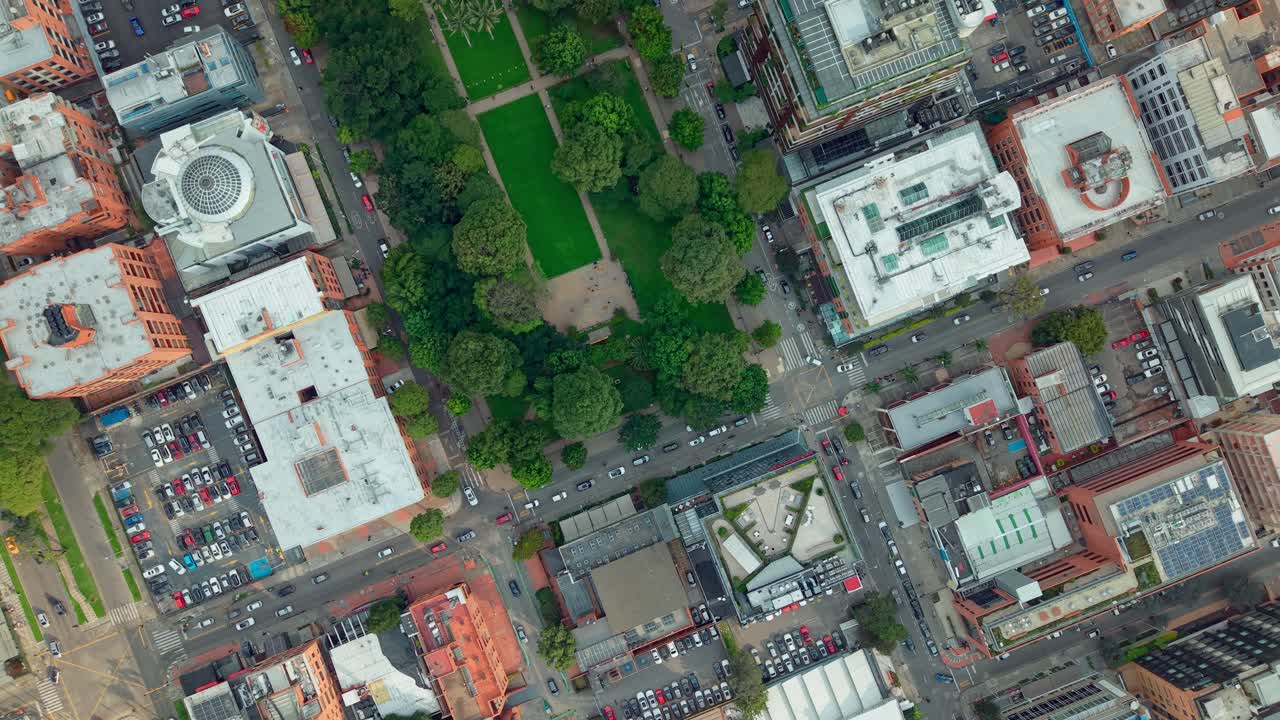 Aerial view captured by a drone of Bogotá, Colombia, with orange houses between tree-lined green streets