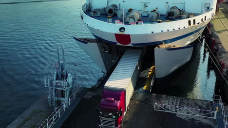 Vehicles-leaving-one-by-one-the-deck-of-a-sea-ferry-by-the-opened-gate