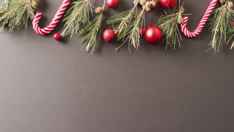 video of christmas decoration with baubles and copy space on grey background