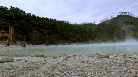 sulphur rises over white crater kawah putih in bandung, indonesia