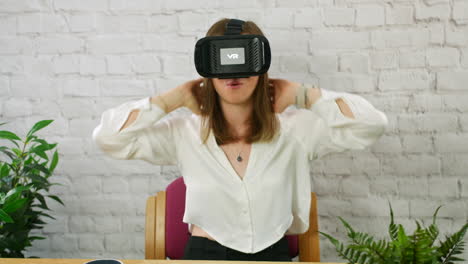 a happy young professional woman putting on a vr virtual reality headset in an office