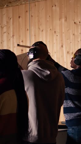 vertical video group of shooting range customers shooting targets with pistols and rifles