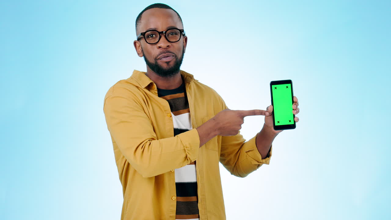 Happy black man, pointing and phone green screen
