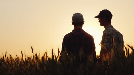 dos jóvenes abrazándose contra el telón de fondo de la puesta de sol mirando hacia el horizonte