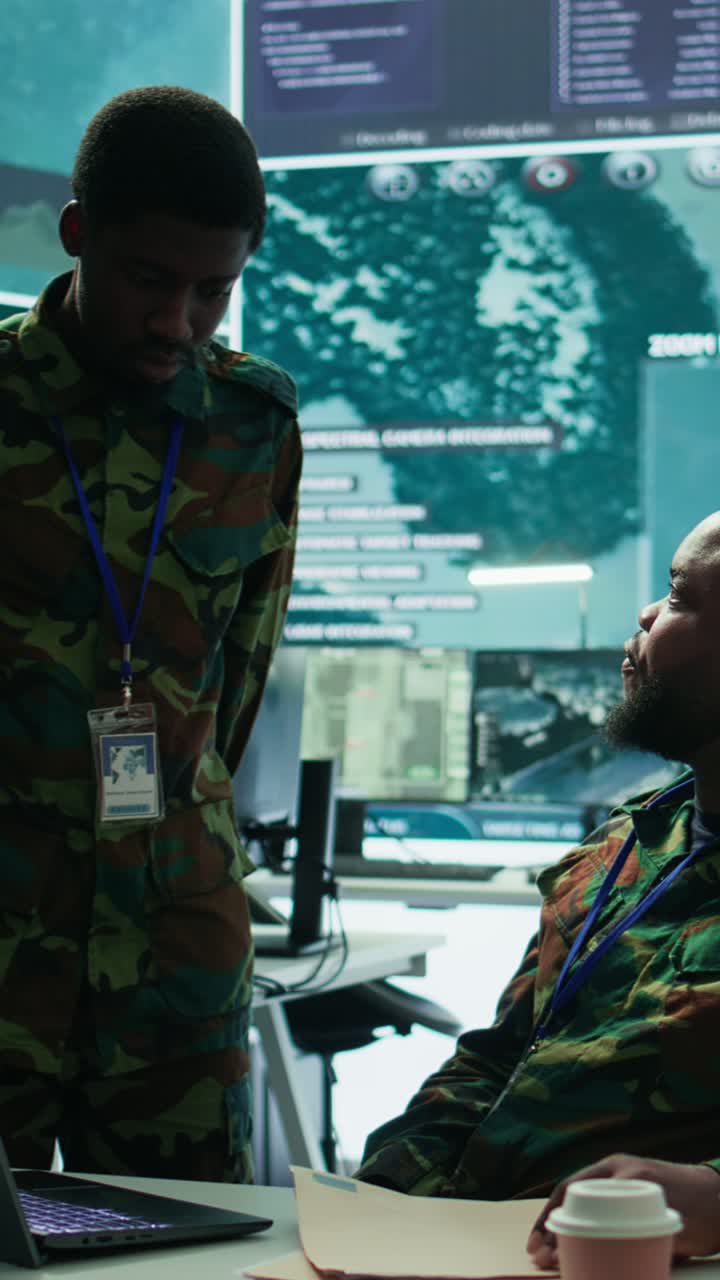 Vertical Video Angry army expert in a command post power base monitors satellite footage