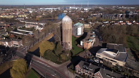 Former-Dutch-brick-water-tower-aerial-in-Zutphen-rising-above-cityscape