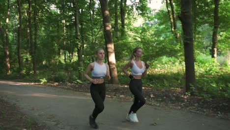 pretty blonde girls running in the park in a sunny day