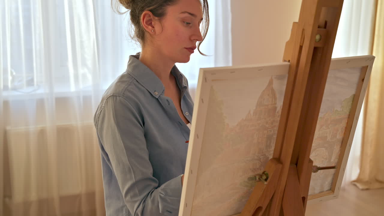 Caucasian woman painting a picture with a palette in her hands, indoors