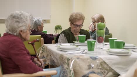 senior people sitting in canteen at nursing home