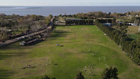 Aerial-over-football-ground-showing-teams-playing-and-practicing-football