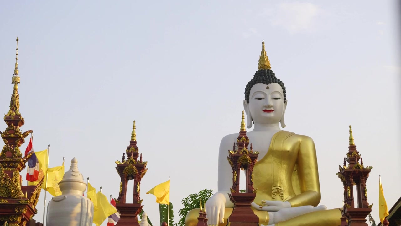 Svelamento in slow motion tramite slider su una statua di Buddha davanti a un tempio thailandese